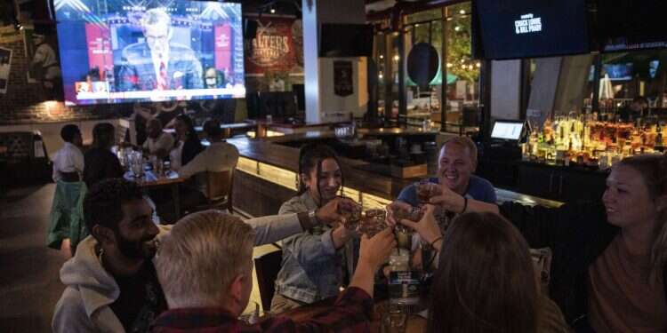 A group of people take shots before they watch the first presidential debate at Walters Sports Bar on September 29, 2020 in Washington, DC 'I'm shaking I'm so mad': Dave Portnoy promises 'to ruin' antisemitic customer