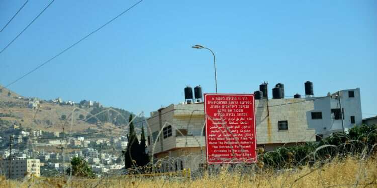 Sign forbidding Israeli citizens from entering into an Area C of the West Bank Italian pro-Palestinian activist plans unauthorized 'resistance' school in Area C