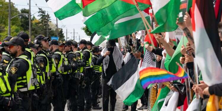Pro-Palestinian protesters gather along the route of the United Jewish Appeal's annual Walk With Israel march in Toronto, Canada, on Sunday, May 25, 2025 Why are Canadian Jews being told to hide?