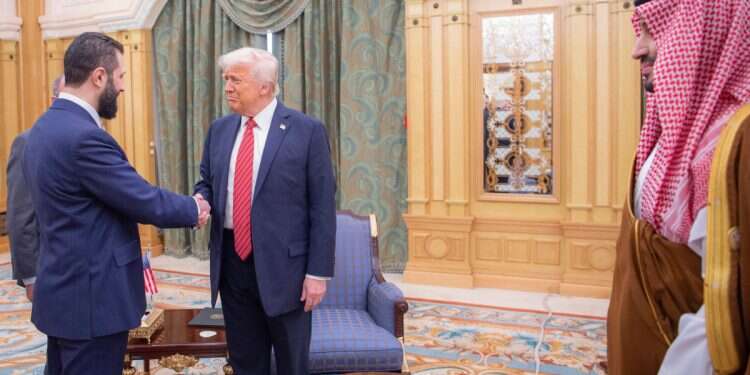 Interim Syrian President Ahmad al-Sharaa shakes hands with US President Donald Trump in Riyadh, Saudi Arabia, Wednesday, May 14, 2025 'A hand that shakes the hand of your murderer': Alawites criticize US-Syria relations