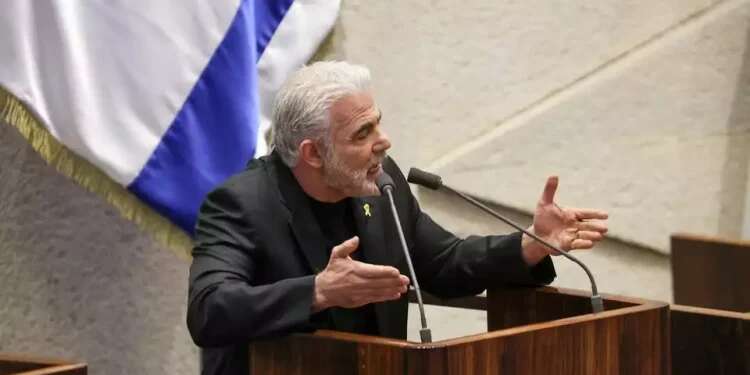 Lapid in the Knesset plenum (archive) Lapid hints Israel funds aid to Gaza through shell companies