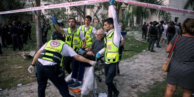 Rescue personnel evacuate a man from an impacted residential building compound following missile attack from Iran on Israel, central Israel June 16, 2025 Iranian barrage claims 8 lives in direct hits