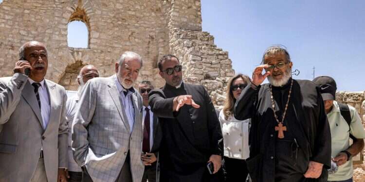 US ambassador to Israel Mike Huckabee (2nd-L) and the Palestinian mayor of the village of Taybeh, Suleiman Khourieh (L), tour the fifth-century Church of St George in the Palestinian Christian village of Taybeh US envoy: I did not blame Jews for Taybeh fire