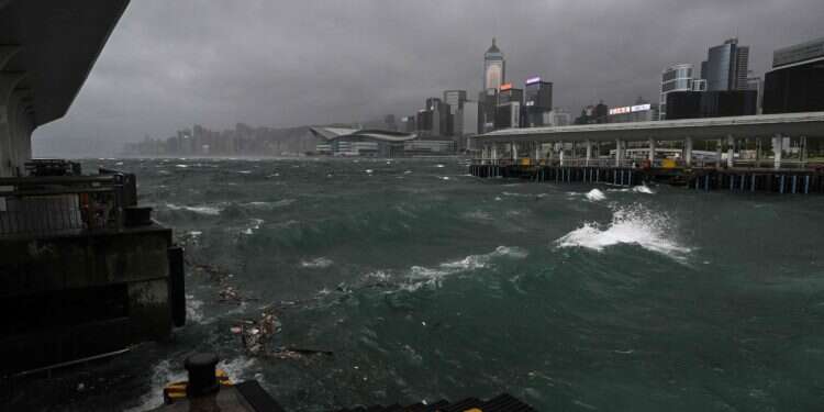 Dark clouds gather and rough seas are seen in Victoria harbour as the typhoon signal number 10 is hoisted as Typhoon Wipha moves towards Hong Kong on July 20, 2025 Hong Kong shuts down under highest storm alert as Typhoon Wipha batters city