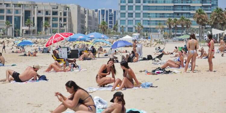 Israelis enjoy the beach in July, amid rising temperatures Scorching heat begins: Israel's crucial 48 hours