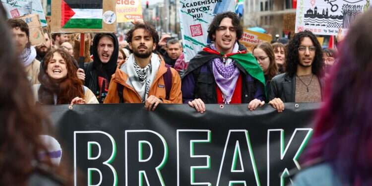 Pro-Palestinian protesters hold placards and show Palestinian colors during the 5th National March for Gaza, in Brussels, Belgium, March 17, 2024 Belgian politician refuses Jewish new year greetings citing Mideast tensions
