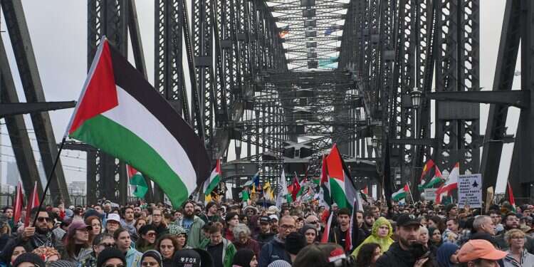 Protesters walk across the Sydney Harbour Bridge during the Palestine Action Group's 'March for Humanity', a pro-Palestinian march, in Sydney, Australia, 03 August 2025 Australia caves to pressure to recognize Palestinian state
