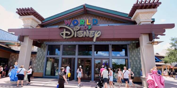Tourists stroll by the World of Disney store at Disney Springs shopping and entertainment district Tuesday, Aug. 5, 2025, in Lake Buena Vista, Fla. Why is no one allowed to die at Disney World?