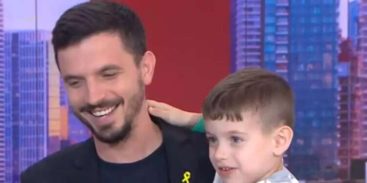 Dean Fisher with his son in the studio after he barged into the studio Reporter's son crashes live TV, turns into co-host