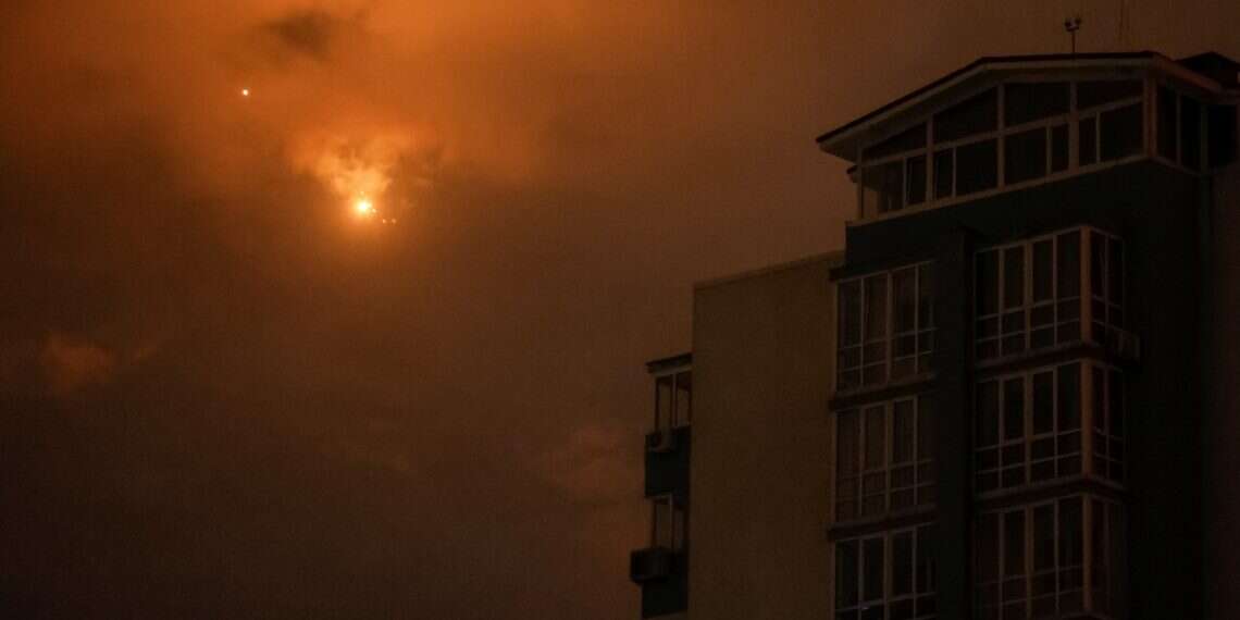 Explosions are seen in the night sky as Ukrainian servicemen fire towards drones during a Russian drone strike, amid Russia's attack on Ukraine, in Kyiv, Ukraine September 10, 2025 Poland intercepts Russian drones in unprecedented NATO test