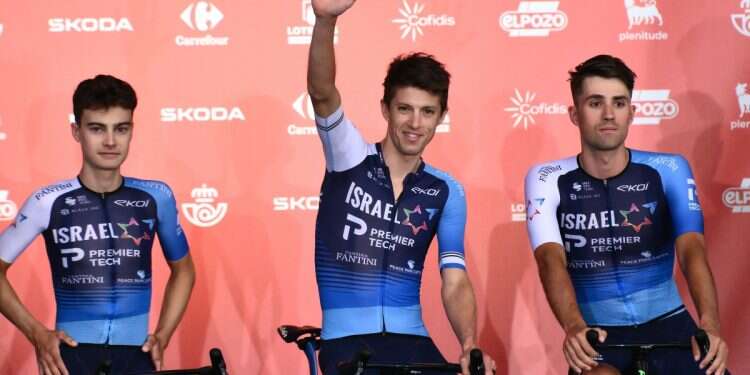 Team Israel Premier Tech 's New Zealander rider George Bennett waves from stage during the official teams presentation of the 80th edition of 'La Vuelta' cycling tour of Spain, in Torino, Italy on August 21, 2025 FM issues sharp response after cycling team removes 'Israel' from uniforms