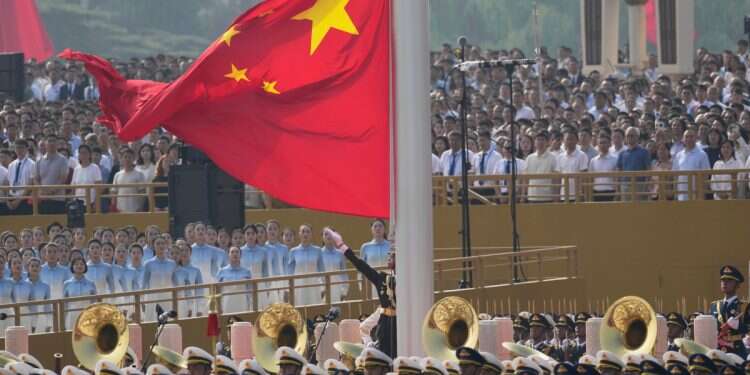 The Chinese flag is raised ahead of a military parade to commemorate the 80th anniversary of Japan's World War II surrender held in front of Tiananmen Gate in Beijing, Wednesday, Sept. 3, 2025. (AP Photo/Ng Han Guan) China says IDF decision on Chinese EVs based 'speculation and lies'