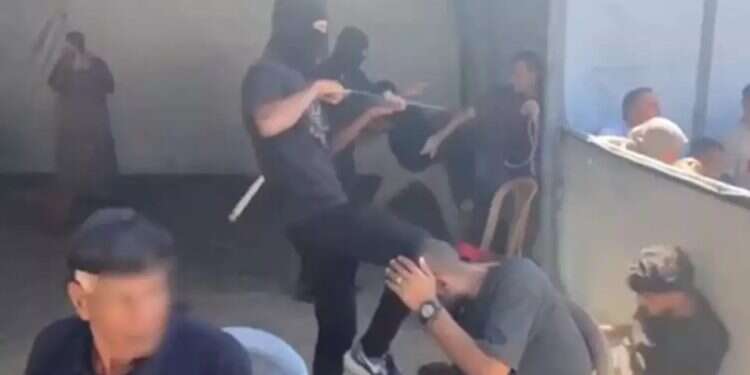 Hamas terrorist abuses Gazans. Photo: Arab netrorks Hamas terrorists abuse Gazans before cheering crowd