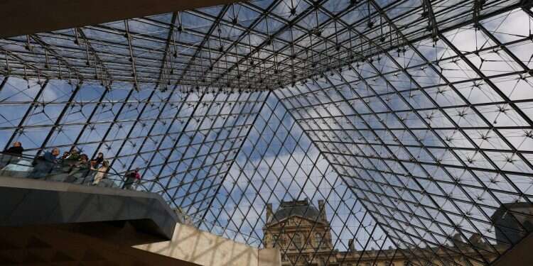 Visitors walk below the glass Pyramid at the Louvre Museum on the day it reopened to the public for the first time since last Sunday's heist, while the Galerie d'Apollon where eight pieces of Napoleon and the Empress's jewelry collection displayed in the gallery were stolen by thieves, remains closed, in Paris, France, October 22, 2025 (Photo: Reuters/Gonzalo Fuentes) Fresh clues emerge in hunt for Louvre heist gang