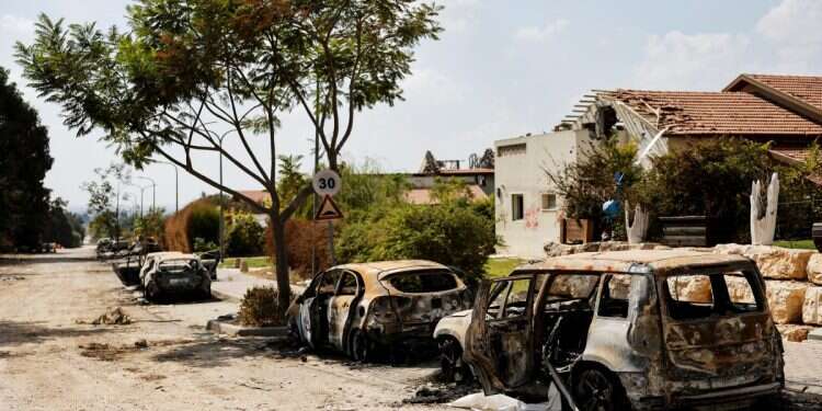 Burnt cars are seen on a road, following a mass infiltration by Hamas terrorists from the Gaza Strip, in Kibbutz Beeri in southern Israel, October 13, 2023 Iran says Oct. 7 was 'a costly mistake'