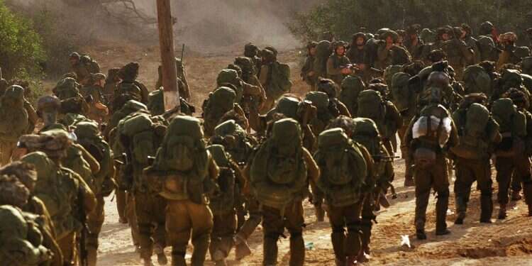 Israeli soldiers walk towards the northern Gaza Strip as seen from the Israeli border with Gaza, Monday, Jan. 12, 2009 Trump: IDF will return to Gaza if Hamas violates ceasefire