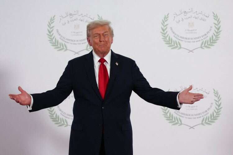 President Donald Trump waits to greet leaders during a summit to support ending the more than two-year Israel-Hamas war in Gaza after a breakthrough ceasefire deal, Monday, Oct. 13, 2025, in Sharm El Sheikh, Egypt