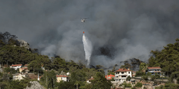 Helicopter extinguishing fire near Turkey's southern coast Turkish trucker fights wildfire with milk tanker