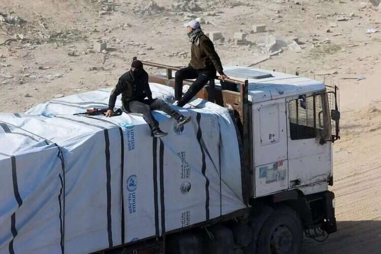 Hamas terrorists on an aid truck. Photo: Reuters