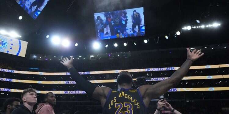 Los Angeles Lakers forward LeBron James (23) throws powdered chalk into the air during the game against the Utah Jazz at Crypto.com Arena LeBron James makes historic season debut
