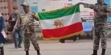 Iranian soldiers raise the country’s original flag bearing the lion emblem Rare protest against Iran's regime in central Tehran
