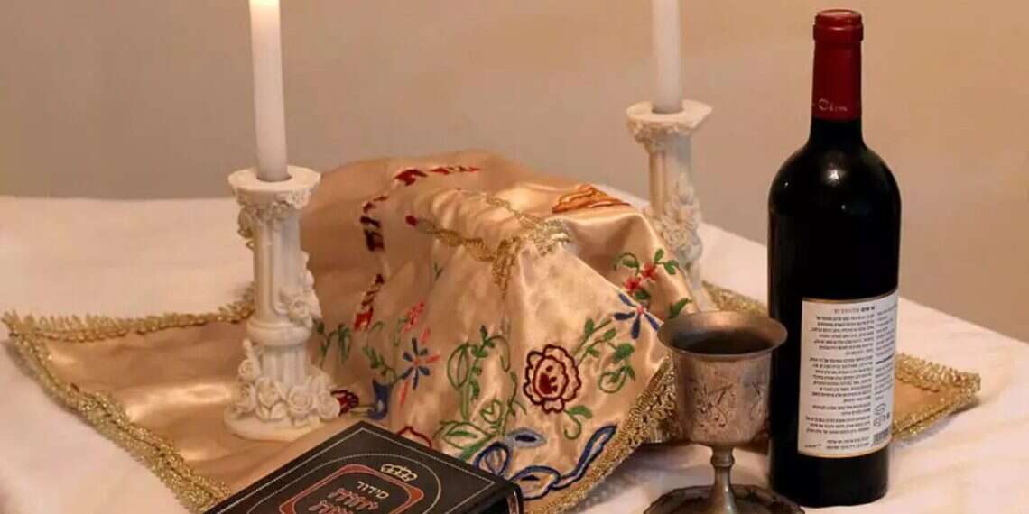 Shabbat candles and Kiddush wine (illustrative). Photo: Koko Shabbat is the solution