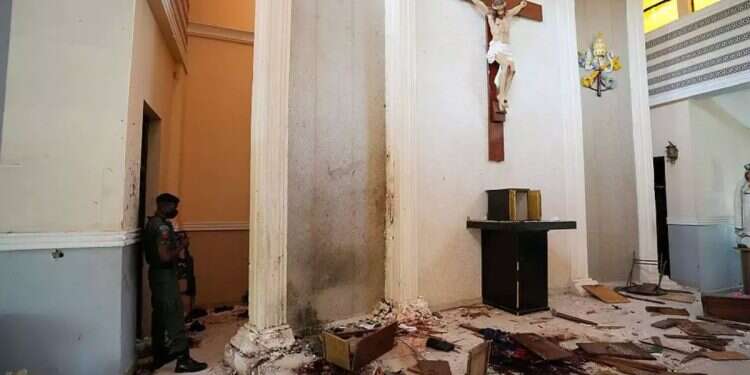 A police officer stands inside a vandalized church in Nigeria. Photo: AP Trump prepares to act – but is there really a genocide against Christians in Nigeria?