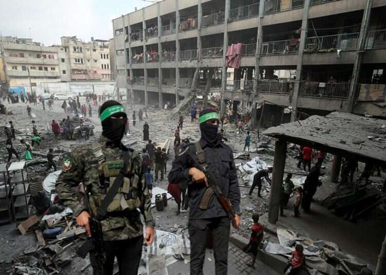 Hamas terrorists (backdrop: Gaza Strip) Israeli leaders choose politics over national security