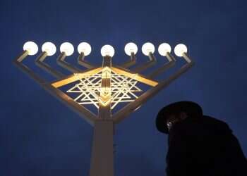 A illuminated Hanukkah menorah stands on Pariser Platz square in front of Brandenburg Gate in Berlin, Germany, 23 December 2014 Hanukkah 2025: Everything you need to know