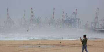 A person walks on an empty beach during stormy weather in Ashdod, Israel, 10 December 2025 Winter storm update: Heavy rain, flood warnings, and road closures
