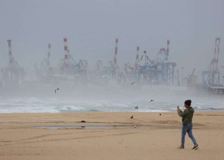 A person walks on an empty beach during stormy weather in Ashdod, Israel, 10 December 2025 Winter storm update: Heavy rain, flood warnings, and road closures