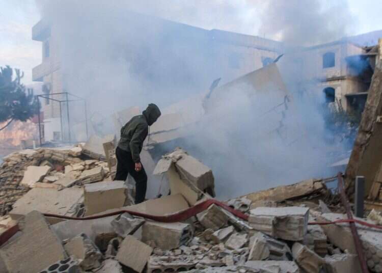 A man looks inspects the damage at the site of an Israeli airstrike that targeted the southern Lebanese village of Jbaa on December 4, 2025 IDF strikes Hezbollah training camp