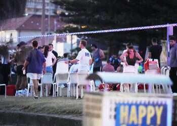 People and emergency workers gather at location where a holiday event was taking place and then a reported shooting at Bondi Beach in Sydney, Sunday, Dec. 14, 2025 WATCH: Bondi Beach hero tackles terrorist, takes gun