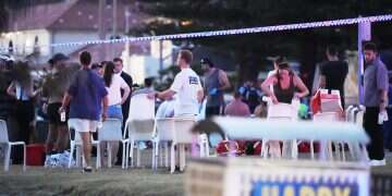 People and emergency workers gather at location where a holiday event was taking place and then a reported shooting at Bondi Beach in Sydney, Sunday, Dec. 14, 2025 WATCH: Bondi Beach hero tackles terrorist, takes gun