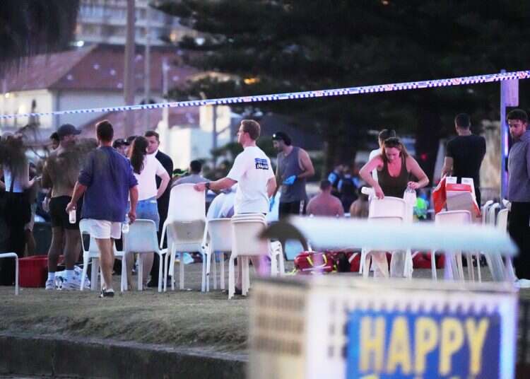 People and emergency workers gather at location where a holiday event was taking place and then a reported shooting at Bondi Beach in Sydney, Sunday, Dec. 14, 2025 WATCH: Bondi Beach hero tackles terrorist, takes gun