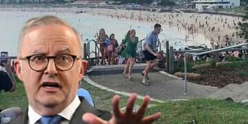 This screen grab of UGC video taken on December 14, 2025 and received courtesy of Mike Ortiz shows beach-goers fleeing Bondi Beach after gunmen opened fire, in Sydney on December 14, 2025 (foreground: PM Albaneses Explosives found at Bondi Beach as police raid suspect home