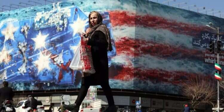An Iranian woman walks past an anti-US billboard in Tehran. Photo: EPA Iran's Trump card is the Gulf states' nightmare scenario