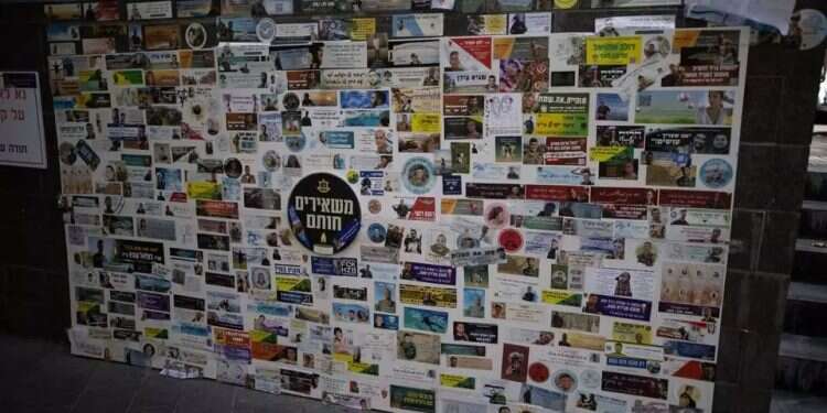 Stickers bearing photos of fallen Israelis in Zion Square. Photo: Oren Ben Hakoon The faces behind 'cleared for publication' are not merely a price