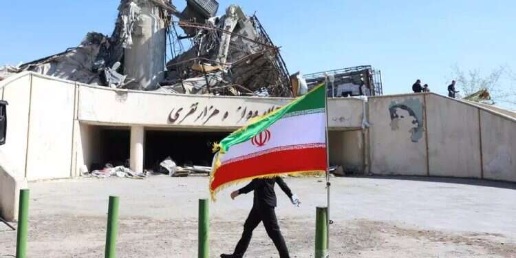An Iranian civilian walks past a destroyed building in Tehran. Photo: EPA US rejects Iranian request for another meeting in Pakistan