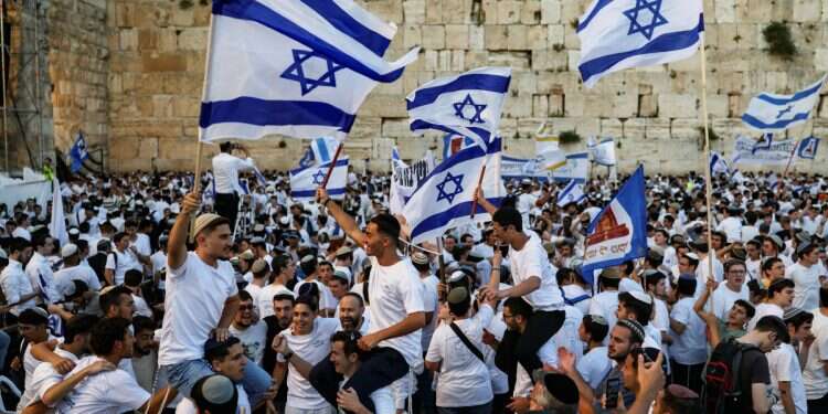 People wave Israeli flags as they gather at the Western Wall, during the annual Jerusalem Day, in Jerusalem's Old City, May 14, 2026 'Coming Home': Jerusalem real estate expo to debut in New York