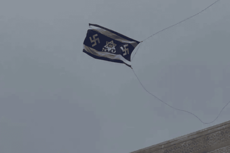 A flag bearing swastikas and a Star of David flies over the New York University campus