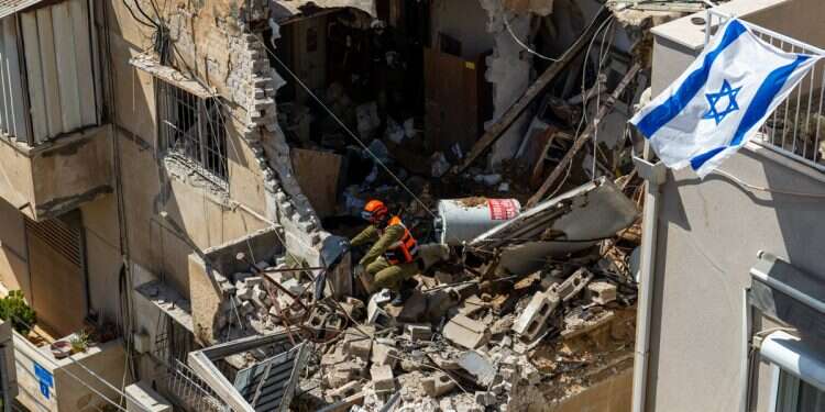 Israeli Home Front Command officers inspect an apartment building struck by an Iranian missile on March 22, 2026 in Tel Aviv, Israel Was it all worth it?