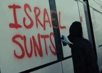An activist spray-paints “Destroy Israel” on a light rail cars Pro-Palestinians vandalize light rail cars bound for Tel Aviv