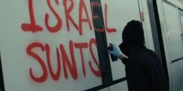 An activist spray-paints “Destroy Israel” on a light rail cars Pro-Palestinians vandalize light rail cars bound for Tel Aviv