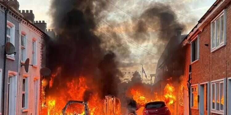 Fire burns in the streets during the riots in Belfast. Photo: AP Belfast burns in night of protests after shocking attack