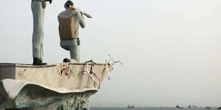 A statue of Islamic Revolutionary Guard Corps members overlooks the Strait of Hormuz. Photo: Reuters Iran's Revolutionary Guards threaten ships over new strait of Hormuz route