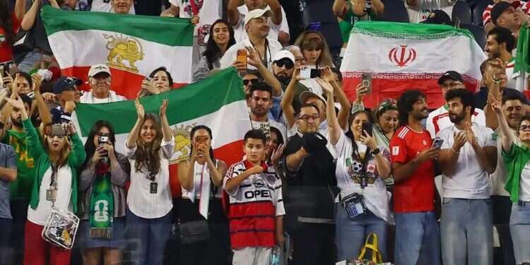 The two Iranian flags in the stands. Photo: Reuters After boos during Iran's anthem, regime supporters and opponents find common ground