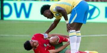 Vinicius Junior stands over Achraf Hakimi as he lies on the pitch. Photo: Shahar Azran Vinicius Junior wonder goal not enough for Brazil against Morocco