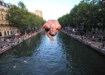 European cool melts in the heat. A Parisian jumps into Canal Saint-Martin last week. Photo: AFP France is melting, but air conditioning is a culture war