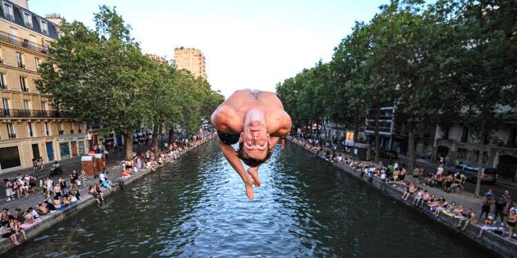 European cool melts in the heat. A Parisian jumps into Canal Saint-Martin last week. Photo: AFP France is melting, but air conditioning is a culture war